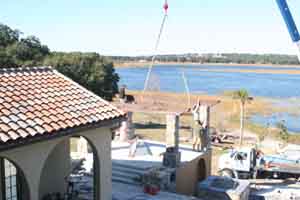 Our general contractor guiding pergola beams into place